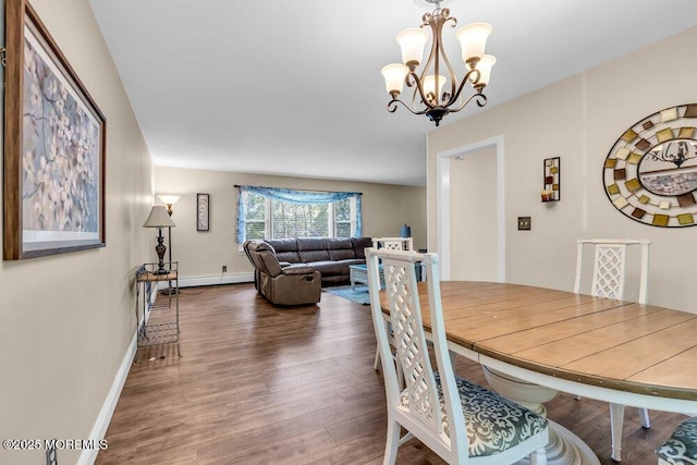 7 E Parkway Pl, Holmdel, NJ 07733 - dining area featuring wood finished floors, a chandelier, baseboards, and a baseboard heating unit