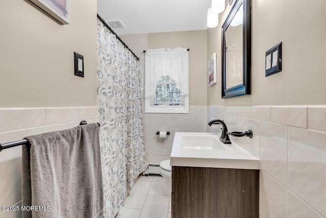 7 E Parkway Pl, Holmdel, NJ 07733 - full bath featuring tile walls, tile patterned floors, vanity, toilet, and a baseboard heating unit