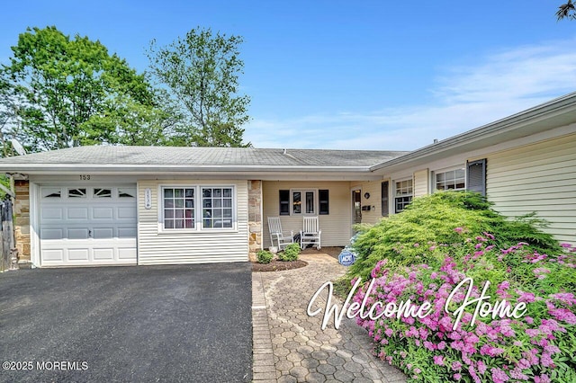 153 Lloyd Rd, Matawan, NJ 07747 - ranch-style home with a garage, driveway, and stone siding