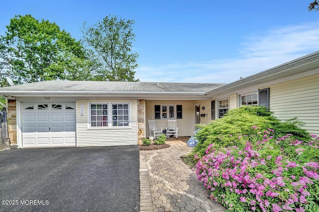 153 Lloyd Rd, Matawan, NJ 07747 - ranch-style house with a garage, driveway, and stone siding