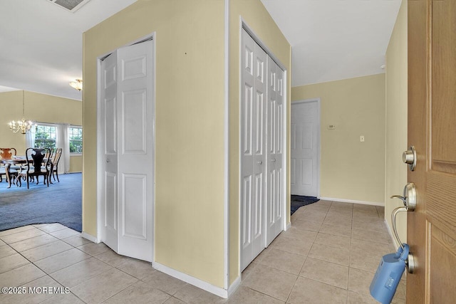 153 Lloyd Rd, Matawan, NJ 07747 - foyer with light tile patterned floors, a chandelier, and light carpet
