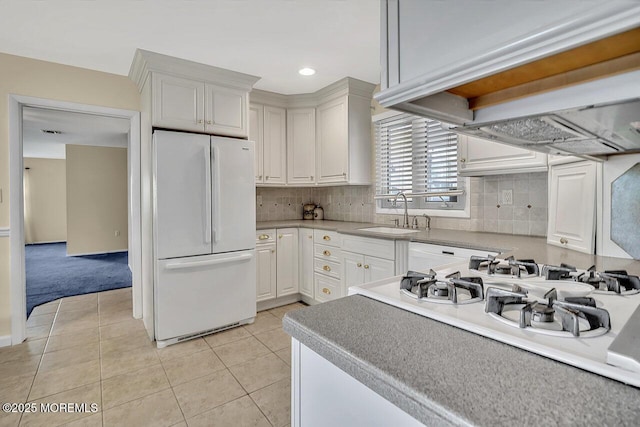 153 Lloyd Rd, Matawan, NJ 07747 - kitchen with freestanding refrigerator, white cabinets, backsplash, light tile patterned floors, and light countertops