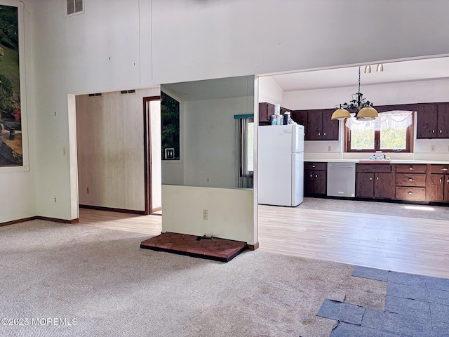 1124 Skiff Way Dr, Forked River, NJ 08731 - kitchen with freestanding refrigerator, dishwasher, a chandelier, light countertops, and light colored carpet