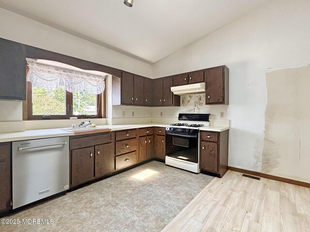 1124 Skiff Way Dr, Forked River, NJ 08731 - kitchen featuring gas range oven, dishwasher, under cabinet range hood, a sink, and light wood-type flooring