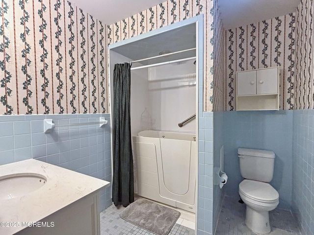 1124 Skiff Way Dr, Forked River, NJ 08731 - bathroom with wallpapered walls, tile walls, a shower with curtain, toilet, and tile patterned flooring