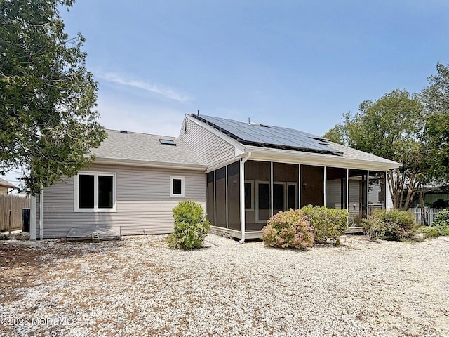 1124 Skiff Way Dr, Forked River, NJ 08731 - rear view of house featuring a sunroom and solar panels
