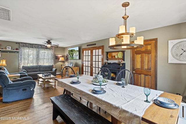 1172 Laurel Dr, Toms River, NJ 08753 - dining area featuring a chandelier, wood finished floors, ceiling fan, and french doors