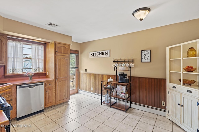 1172 Laurel Dr, Toms River, NJ 08753 - kitchen featuring dishwasher, a wainscoted wall, wood walls, light tile patterned flooring, and brown cabinets
