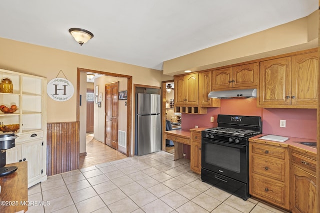 1172 Laurel Dr, Toms River, NJ 08753 - kitchen with gas stove, freestanding refrigerator, under cabinet range hood, light tile patterned floors, and light countertops
