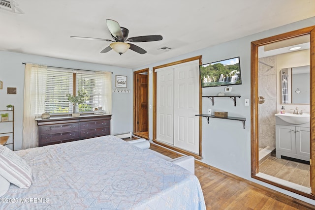 1172 Laurel Dr, Toms River, NJ 08753 - bedroom featuring wood finished floors, baseboard heating, ceiling fan, ensuite bathroom, and a closet