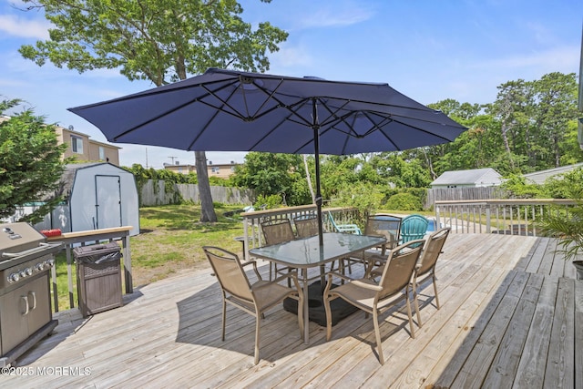 1172 Laurel Dr, Toms River, NJ 08753 - wooden deck with outdoor dining area, a storage shed, and a fenced backyard