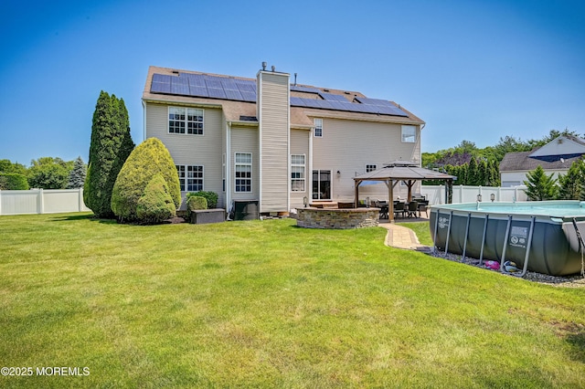 201 Manfre Ct, Freehold, NJ 07728 - rear view of property featuring a gazebo, solar panels, a patio area, and a chimney