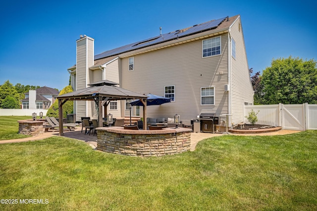 201 Manfre Ct, Freehold, NJ 07728 - rear view of property featuring a gazebo, solar panels, a patio area, a chimney, and a gate