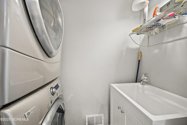 201 Manfre Ct, Freehold, NJ 07728 - laundry area featuring stacked washer / drying machine and cabinet space