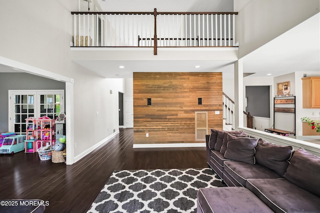 201 Manfre Ct, Freehold, NJ 07728 - living area with a high ceiling, wooden walls, wood finished floors, stairs, and baseboards