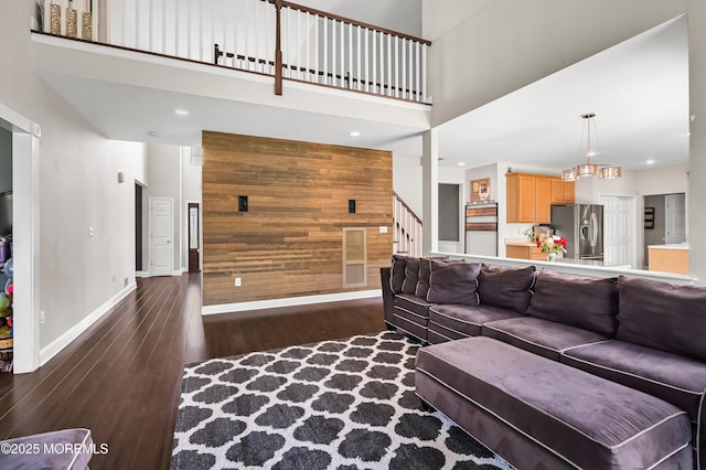 201 Manfre Ct, Freehold, NJ 07728 - living area with wood walls, a high ceiling, wood finished floors, stairway, and baseboards