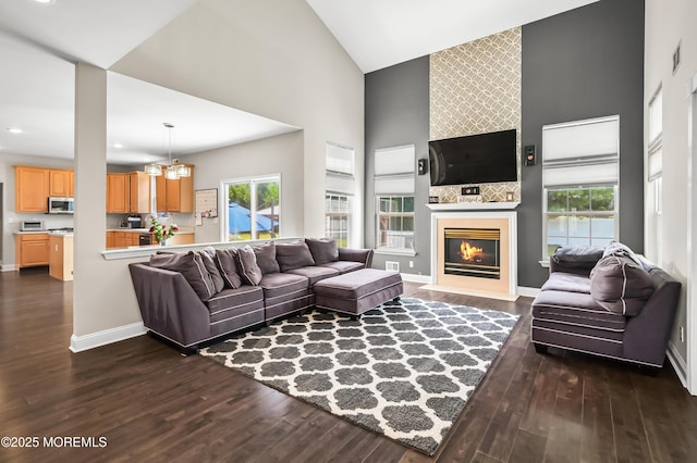 201 Manfre Ct, Freehold, NJ 07728 - living room featuring high vaulted ceiling, dark wood finished floors, a fireplace, a chandelier, and baseboards