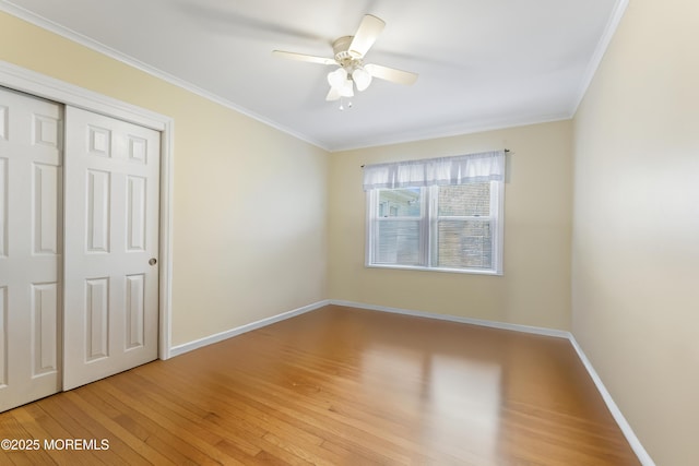 96 Gordons Corner Rd, Manalapan, NJ 07726 - unfurnished bedroom featuring light wood-style flooring, baseboards, ornamental molding, a closet, and ceiling fan