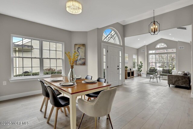 6 Isabella Dr, Manchester, NJ 08759 - dining room with a chandelier, baseboards, light wood-style floors, and vaulted ceiling