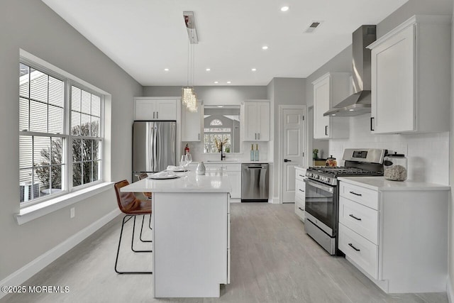 6 Isabella Dr, Manchester, NJ 08759 - kitchen featuring stainless steel appliances, wall chimney range hood, white cabinetry, light wood-type flooring, and recessed lighting