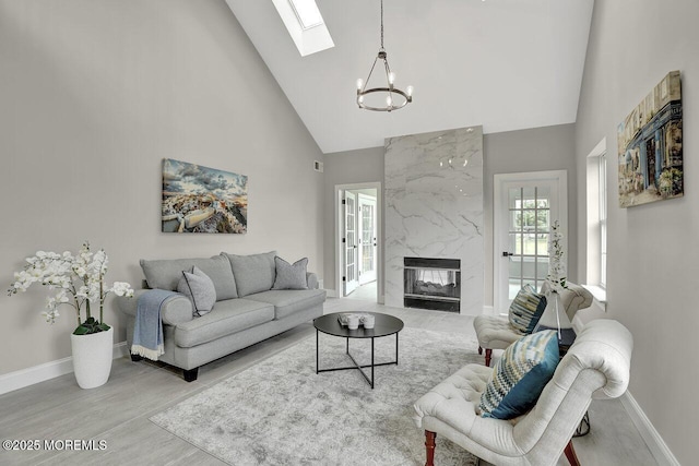 6 Isabella Dr, Manchester, NJ 08759 - living area with high vaulted ceiling, a chandelier, baseboards, a skylight, and wood finished floors