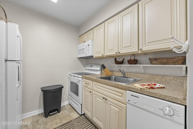 100 Seaview Ave Unit 4-12, Monmouth Beach, NJ 07750 - kitchen with white appliances, a sink, baseboards, light countertops, and cream cabinetry