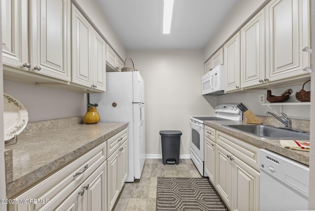 100 Seaview Ave Unit 4-12, Monmouth Beach, NJ 07750 - kitchen with white appliances, a sink, white cabinets, baseboards, and light countertops