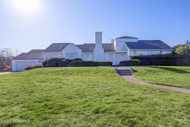 58 Ocean Ave, Deal, NJ 07723 - view of front facade featuring a chimney, a front yard, a garage, and driveway