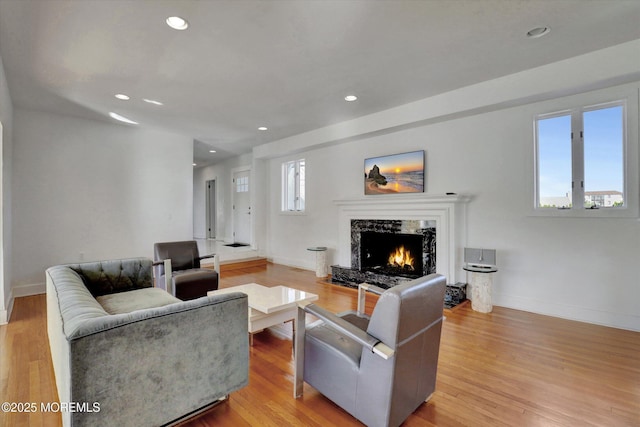 58 Ocean Ave, Deal, NJ 07723 - living room with a high end fireplace, baseboards, recessed lighting, and light wood-style flooring