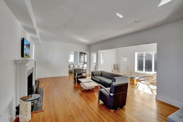 58 Ocean Ave, Deal, NJ 07723 - living room with arched walkways, wood finished floors, a fireplace, baseboards, and recessed lighting