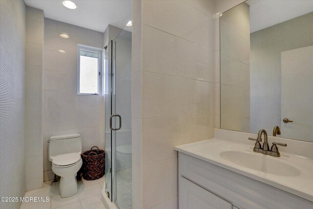 58 Ocean Ave, Deal, NJ 07723 - bathroom with toilet, tile walls, vanity, tile patterned floors, and a shower stall