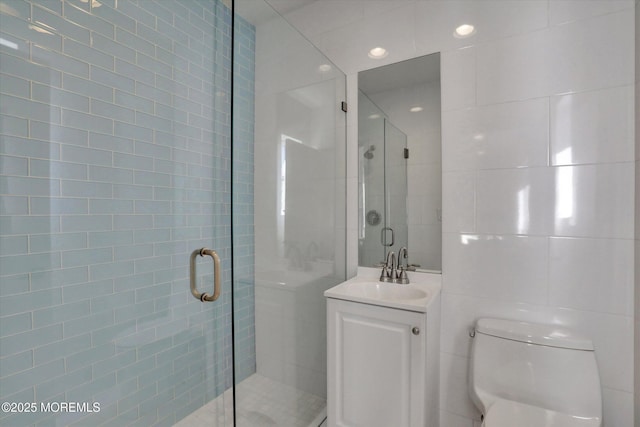 58 Ocean Ave, Deal, NJ 07723 - bathroom with vanity, toilet, a shower stall, tile walls, and recessed lighting