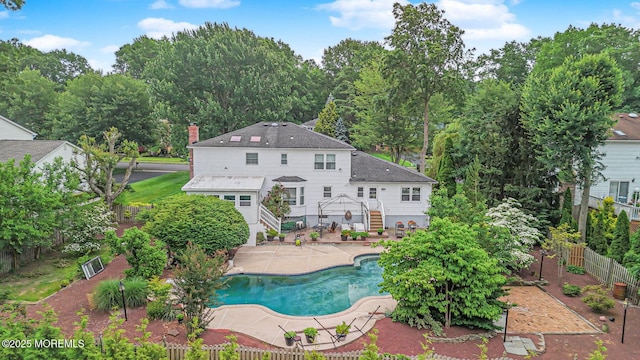 6 Quid Pl, Manalapan, NJ 07726 - view of swimming pool with stairway, a patio, and view of wooded area