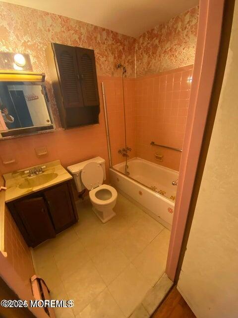 10 Hemlock St Unit D, Toms River, NJ 08757 - full bathroom with wallpapered walls, toilet, vanity, washtub / shower combination, and tile patterned floors