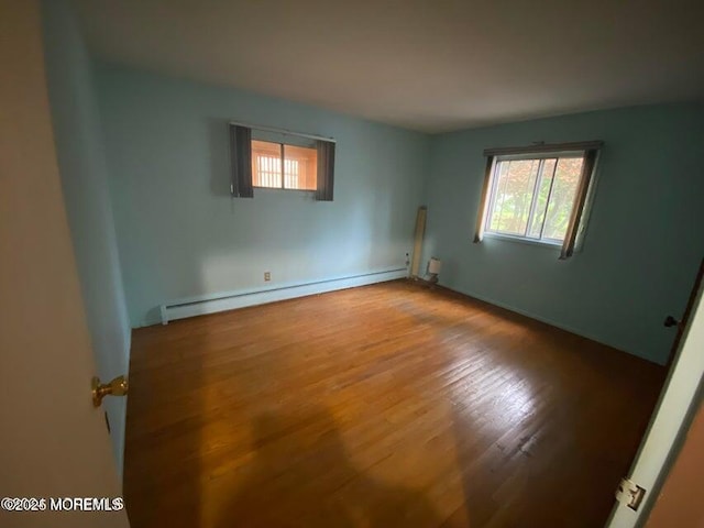 10 Hemlock St Unit D, Toms River, NJ 08757 - unfurnished room with baseboard heating, wood finished floors, and baseboards