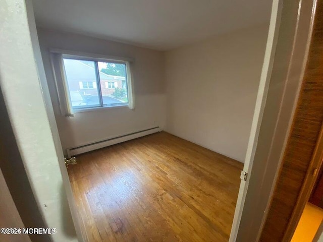 10 Hemlock St Unit D, Toms River, NJ 08757 - unfurnished bedroom featuring a baseboard radiator and light wood-style flooring
