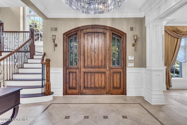 23 Pilgrim Way, Colts Neck, NJ 07722 - foyer entrance with a decorative wall, decorative columns, a chandelier, ornamental molding, and a wainscoted wall