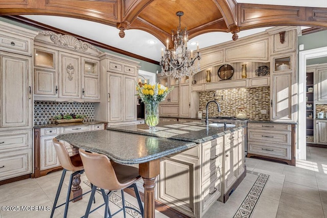 23 Pilgrim Way, Colts Neck, NJ 07722 - kitchen featuring decorative backsplash, cream cabinets, coffered ceiling, a chandelier, and an island with sink