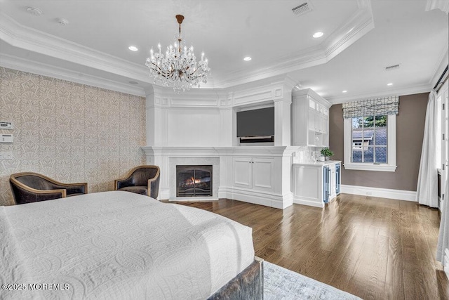 23 Pilgrim Way, Colts Neck, NJ 07722 - bedroom with dark wood finished floors, a warm lit fireplace, a chandelier, ornamental molding, and recessed lighting