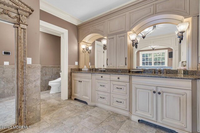 23 Pilgrim Way, Colts Neck, NJ 07722 - full bathroom featuring double vanity, crown molding, toilet, tile walls, and wainscoting