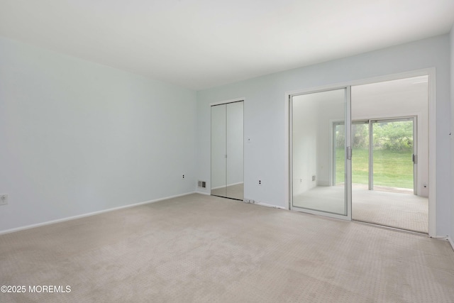 40 Smoke Tree Ter Unit 142, Red Bank, NJ 07701 - unfurnished bedroom featuring light carpet, multiple closets, and access to outside