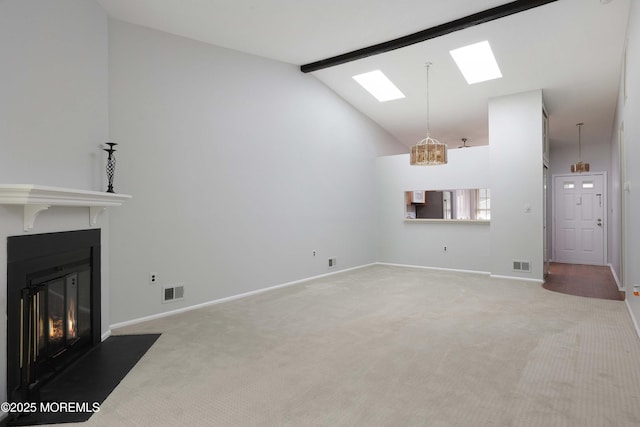 40 Smoke Tree Ter Unit 142, Red Bank, NJ 07701 - unfurnished living room featuring carpet flooring, a skylight, beam ceiling, a fireplace with flush hearth, and high vaulted ceiling