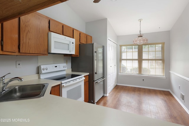 40 Smoke Tree Ter Unit 142, Red Bank, NJ 07701 - kitchen with white appliances, vaulted ceiling, light countertops, brown cabinets, and light wood-style floors