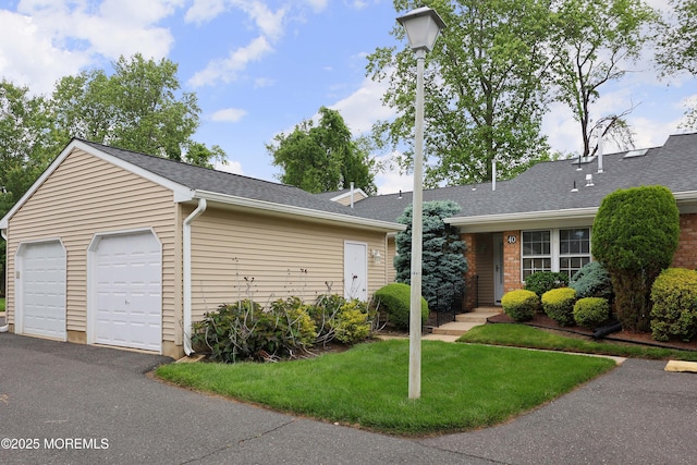 40 Smoke Tree Ter Unit 142, Red Bank, NJ 07701 - view of front of house with a detached garage, a front yard, and roof with shingles