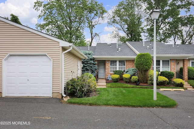 40 Smoke Tree Ter Unit 142, Red Bank, NJ 07701 - townhome / multi-family property with a front yard, roof with shingles, and brick siding