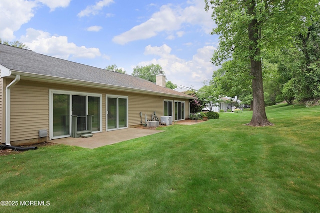40 Smoke Tree Ter Unit 142, Red Bank, NJ 07701 - back of property featuring a chimney, a lawn, a patio area, and roof with shingles