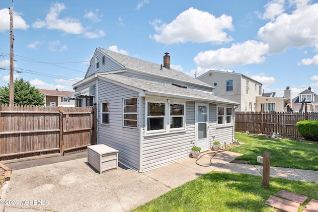 164 Holly St, Port Reading, NJ 07064 - back of property featuring a patio area, roof with shingles, and a chimney
