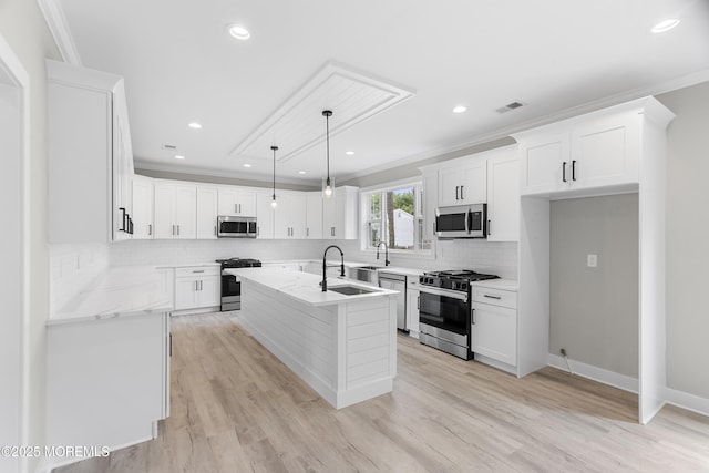 801 Commonwealth Blvd, Toms River, NJ 08757 - kitchen with stainless steel appliances, crown molding, a kitchen island with sink, backsplash, and white cabinetry