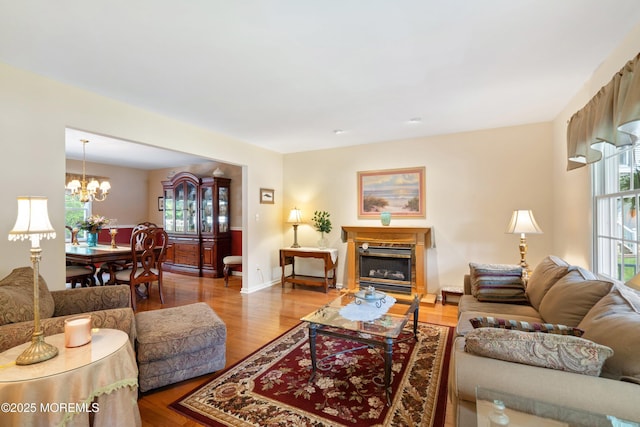 1102 Schencks Mill Line Rd, Toms River, NJ 08753 - living area featuring a chandelier, wood finished floors, a glass covered fireplace, and baseboards