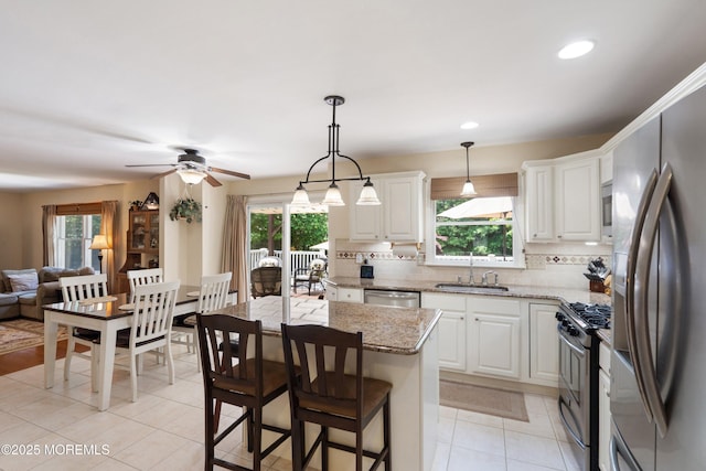 1102 Schencks Mill Line Rd, Toms River, NJ 08753 - kitchen with stainless steel appliances, a sink, backsplash, open floor plan, and white cabinets